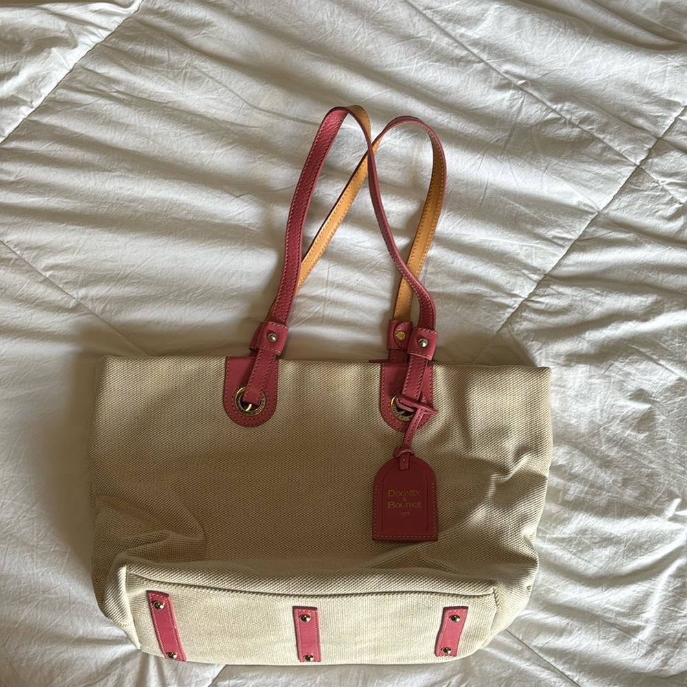 Dooney and Burke. Cream woven/canvas like material. Pink leather handles.